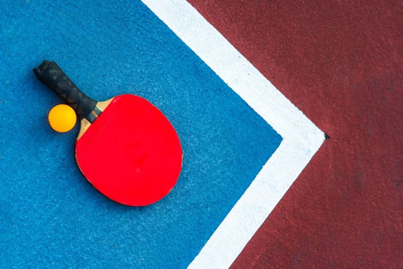 Two paddles laid out with balls